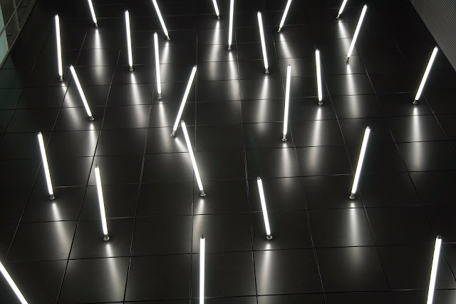 Hans Peter Kuhn, "A Vertical Lightfield", 2009, Fluorescent tubes, loudspeaker, servo drives, computer, aluminium panels, Permanent light and sound installation in Orchard Central, Singapore, Courtesy of the artist